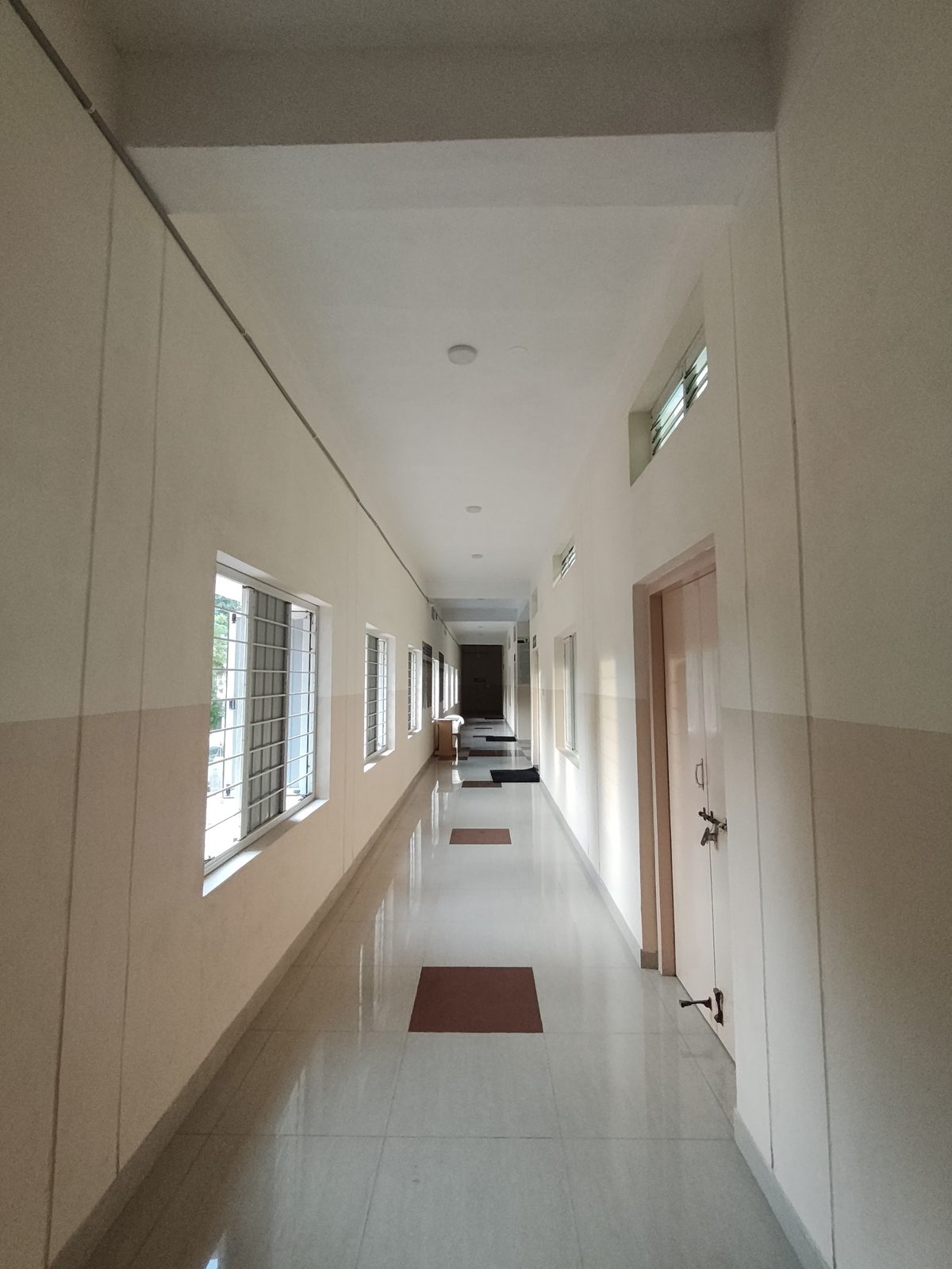 Well-lit corridor connecting classrooms and offices