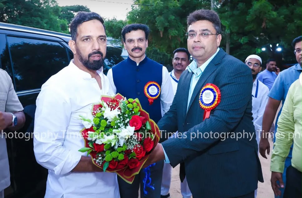 Official being felicitated with a bouquet