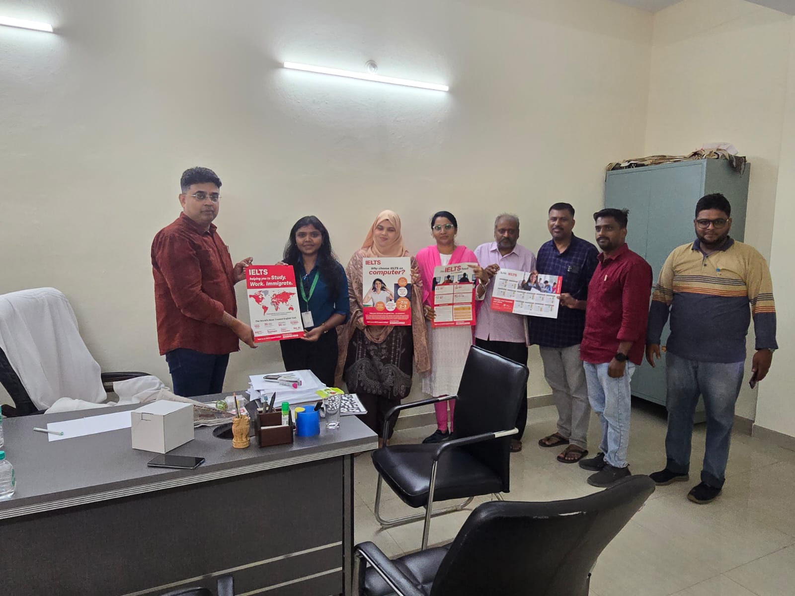 Team members with IELTS awareness materials